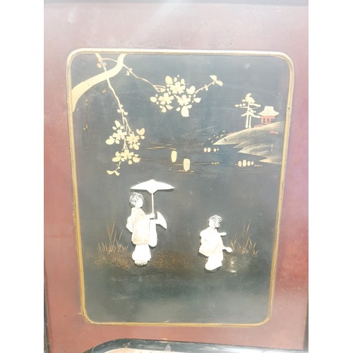 198 - A vintage Japanese carved wooden two leaf screen decorated with relief figures of mother of pearl an... 