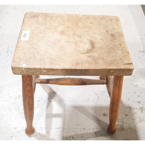 202 - An antique elm four legged stool, height 39.5cm. No shipping. Arrange collection or your own packer ... 