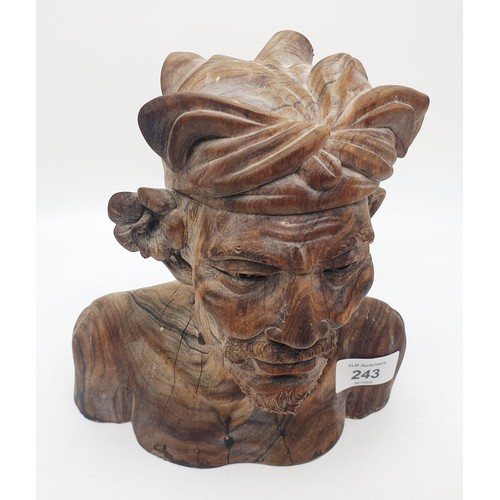 243 - A carved wooden bust of a tribesman, height 21.5cm. UK shipping £14.