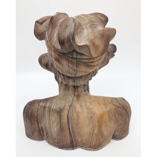 243 - A carved wooden bust of a tribesman, height 21.5cm. UK shipping £14.