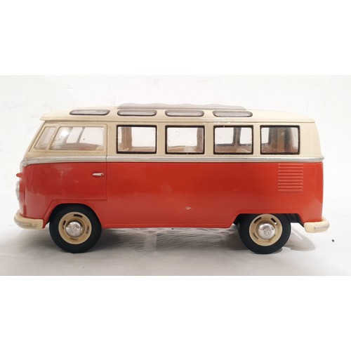 332 - Two tin plate VW  camper wall plaques, the longest 81.5cm together with a model of a VW camper van. ... 