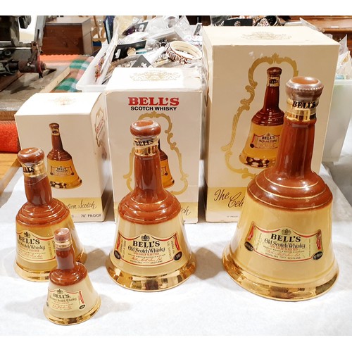 21A - Four sealed bottles of Bells Scotch whisky in Wade decanters: 75cl, 37.8cl, 18.9cl and a miniature. ... 