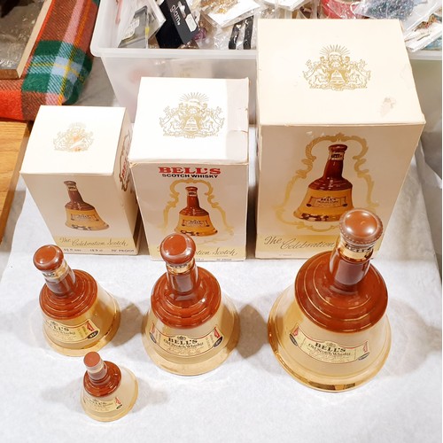 21A - Four sealed bottles of Bells Scotch whisky in Wade decanters: 75cl, 37.8cl, 18.9cl and a miniature. ... 