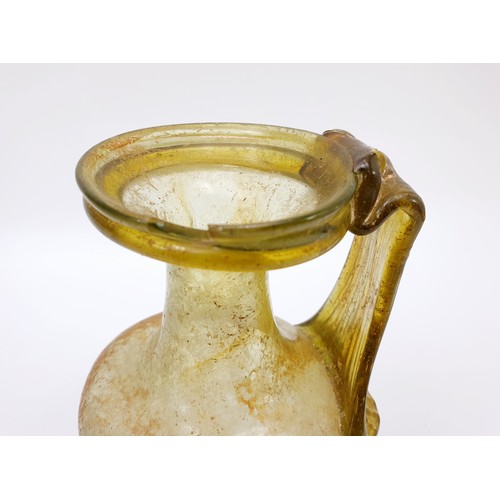 40 - Antiquities: a Roman green glass jug with label to base from the J. R. Preece Collection, height 18c... 