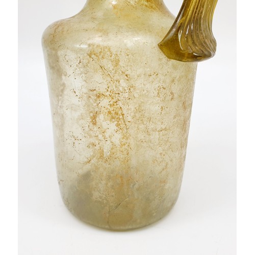 40 - Antiquities: a Roman green glass jug with label to base from the J. R. Preece Collection, height 18c... 