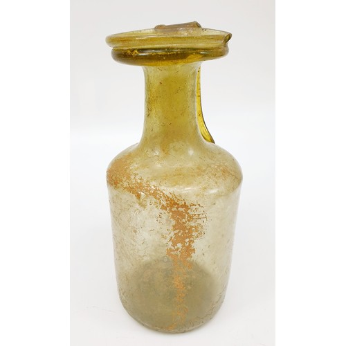 40 - Antiquities: a Roman green glass jug with label to base from the J. R. Preece Collection, height 18c... 