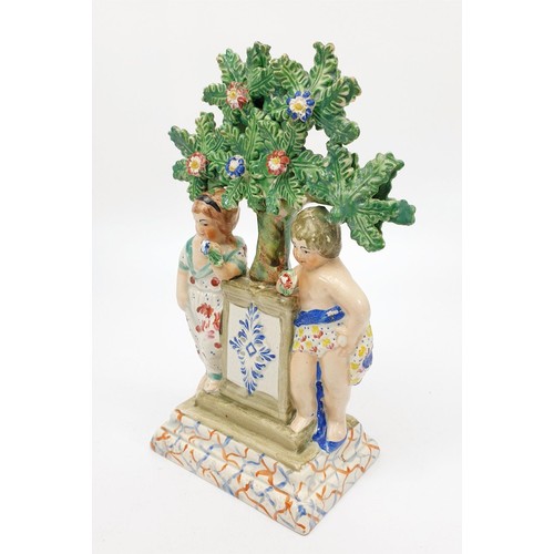 51 - A 19th century Staffordshire pearlware bocage figure of two children around a plinth, height 19.5cm.... 