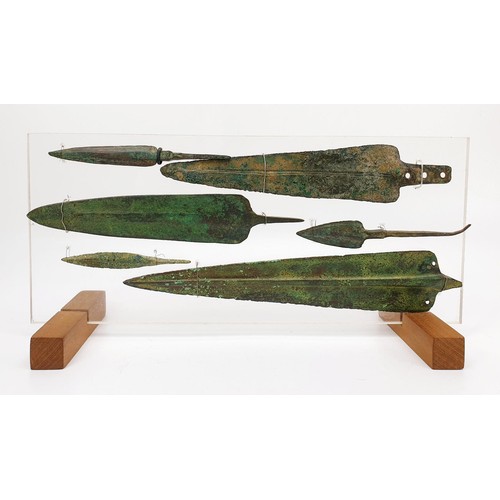 106 - Antiquities: six ancient bronze spear heads mounted on an acrylic panel, the longest 23.5cm. No ship... 