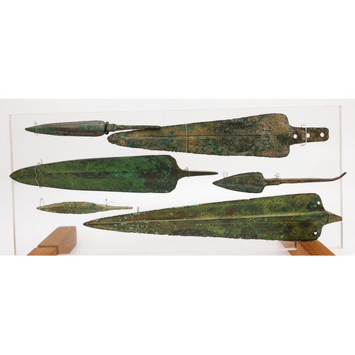 106 - Antiquities: six ancient bronze spear heads mounted on an acrylic panel, the longest 23.5cm. No ship... 