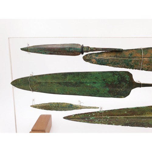 106 - Antiquities: six ancient bronze spear heads mounted on an acrylic panel, the longest 23.5cm. No ship... 