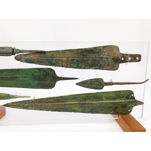 106 - Antiquities: six ancient bronze spear heads mounted on an acrylic panel, the longest 23.5cm. No ship... 