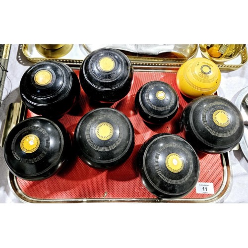 11 - Four Thomas Taylor lawn bowls, two others and two jacks. UK shipping £14.