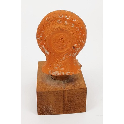 12 - An ancient Egyptian-Romano terracotta woman's head from a figure, on a later plinth, height 90mm. No... 