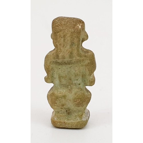 16 - A ancient Egyptian faience amulet in the form of the god  Bes, height 22mm. UK shipping £14.