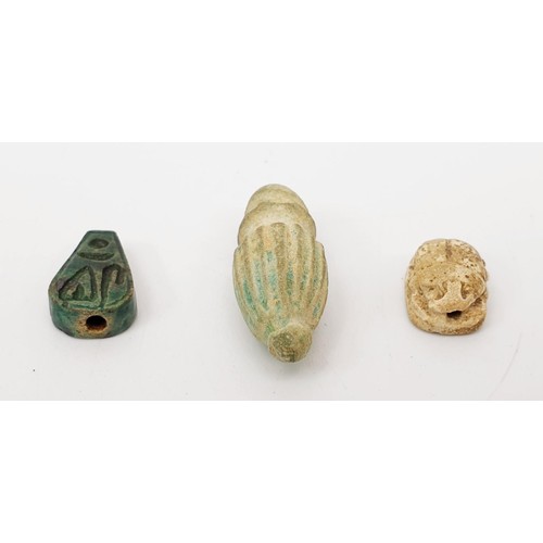 21 - An ancient Egyptian faience bead with hieroglyphs, length 13mm, a scarab seal, width 11mm and a faie... 