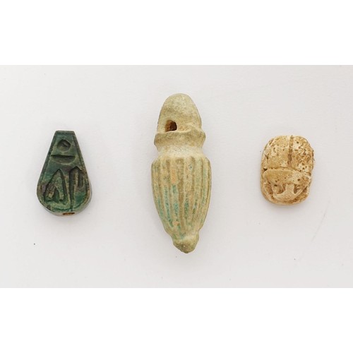 21 - An ancient Egyptian faience bead with hieroglyphs, length 13mm, a scarab seal, width 11mm and a faie... 