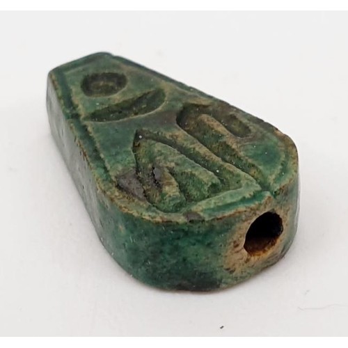 21 - An ancient Egyptian faience bead with hieroglyphs, length 13mm, a scarab seal, width 11mm and a faie... 