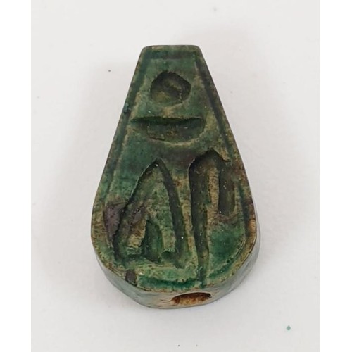 21 - An ancient Egyptian faience bead with hieroglyphs, length 13mm, a scarab seal, width 11mm and a faie... 