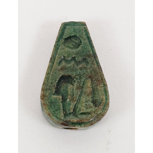 21 - An ancient Egyptian faience bead with hieroglyphs, length 13mm, a scarab seal, width 11mm and a faie... 