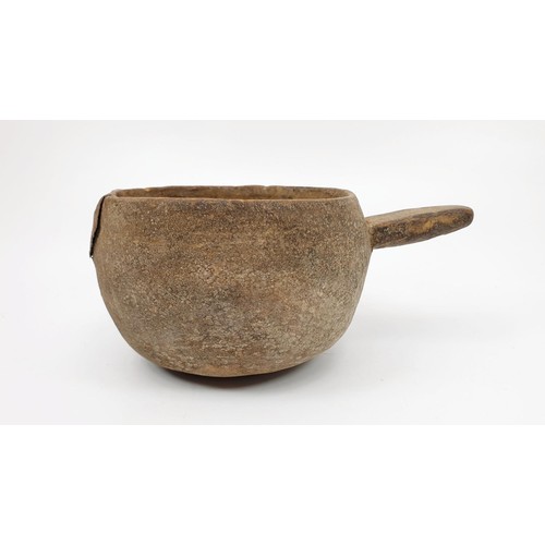 30 - An ancient clay pot with grooved markings inside the bowl and a metal repair, diameter 117cm. No shi... 