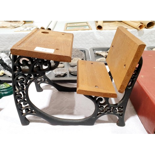 73 - A miniature school desk formed from two wrought iron brackets, height 22cm. UK shipping £14.