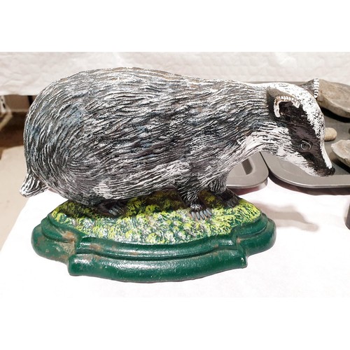 74 - A cast iron badger door stop, width 27cm together with a cast iron pig door stop, width 21cm. UK shi... 