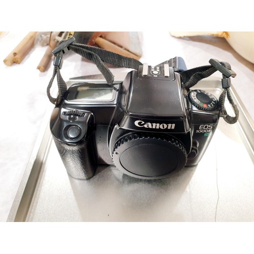 115 - A Canon EOS 1000F camera body together with a Vivitar 28-210mm lens, fitment unknown. UK shipping £1... 