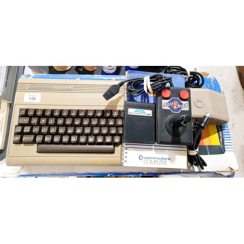 146 - A boxed Commodore 64 computer with a Sure Shot joystick and Radar Rat Race cartridge. Electricals ar... 