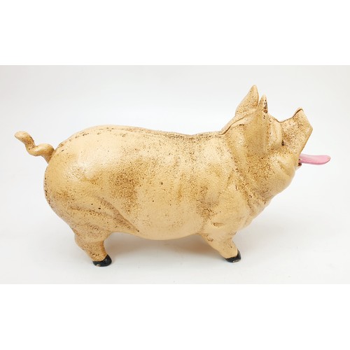 210 - A cast iron coin eating pig moneybox, length 21cm. UK shipping £14.