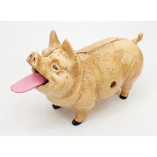 210 - A cast iron coin eating pig moneybox, length 21cm. UK shipping £14.