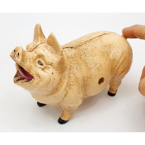 210 - A cast iron coin eating pig moneybox, length 21cm. UK shipping £14.