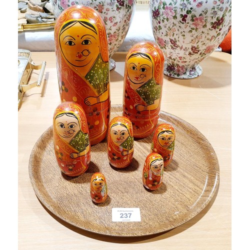 237 - A seven layer Russian doll nesting set, the tallest 22cm which is also glued together. UK shipping £... 