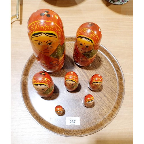 237 - A seven layer Russian doll nesting set, the tallest 22cm which is also glued together. UK shipping £... 