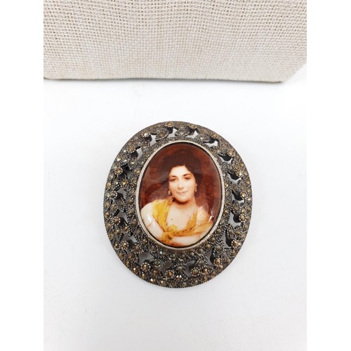 41E - A silver and marcasite brooch inset with a ceramic panel printed with a portrait of a lady, length 5... 