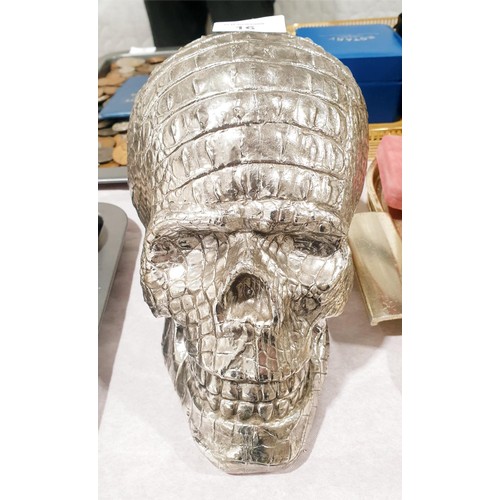 16 - A resin skull with a crocodile grain finish, height 18cm. UK shipping £14.