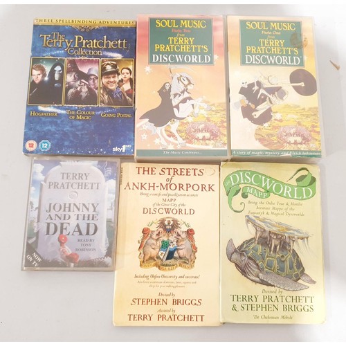 30 - A selection of Terry Pratchett Discworld and other books including Equal Rites hardback, VHS cassett... 