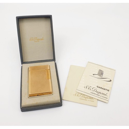 289 - A boxed S. T. Dupont gold plated lighter with paperwork. UK shipping £14.