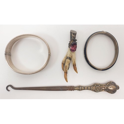 27 - Two silver bangles, a silver mounted grouse foot, a fruit knife with a silver blade and mother of pe... 