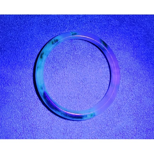 30 - A treated jade bangle, internal diameter 5.5cm. UK shipping £14.