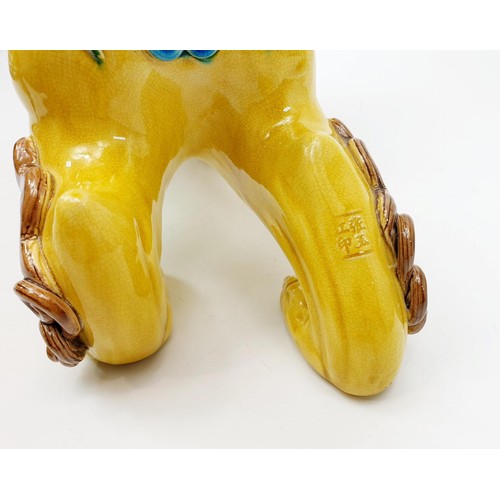 65 - A ceramic Chinese Dog of Fo/Foo, A/F, signed, length 32cm. No shipping. Arrange collection or your o... 