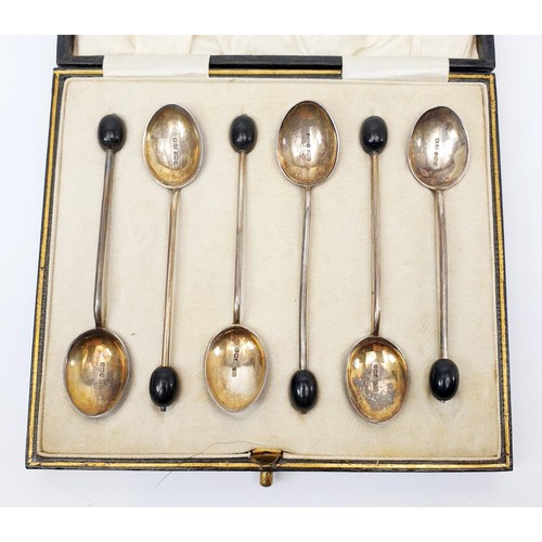 15 - A cased set of hallmarked silver coffee spoons with enamelled bowls and bean knops, one A/F, gross w... 