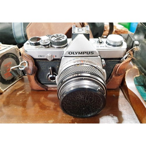 115 - An Olympus OM2 camera with an Olympus 50mm lens together with camera accessories and lenses. UK ship... 