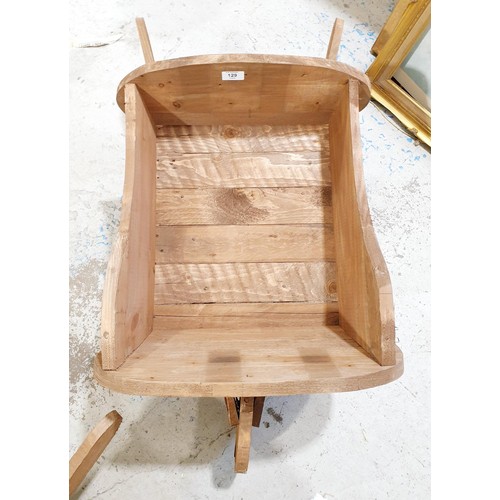 129 - A wooden planter in the form of a wheelbarrow, length 103cm. No shipping. Arrange collection or your... 