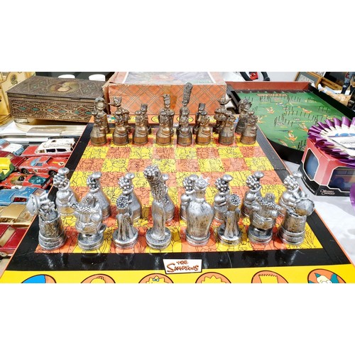 162 - A boxed Simpson's chess set, board size 47x37cm. UK shipping £14.