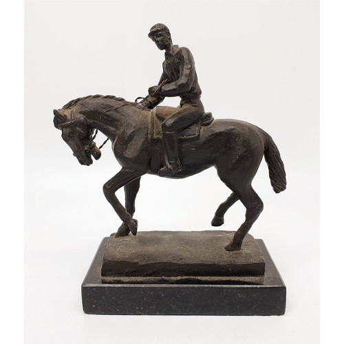 246 - A cast metal sculpture of a horse and jockey on a marble plinth, height 16cm. UK shipping £14.