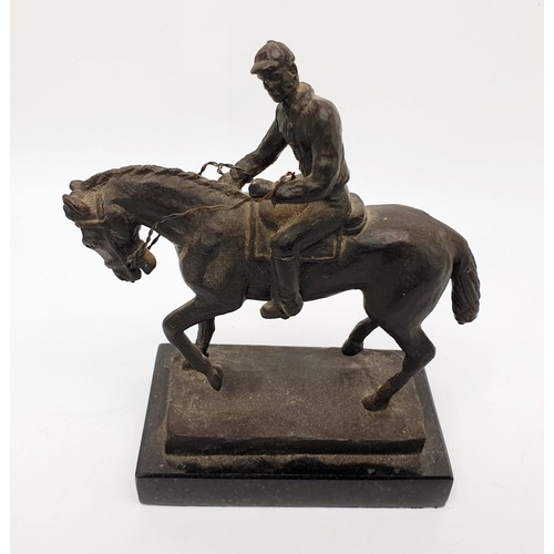 246 - A cast metal sculpture of a horse and jockey on a marble plinth, height 16cm. UK shipping £14.