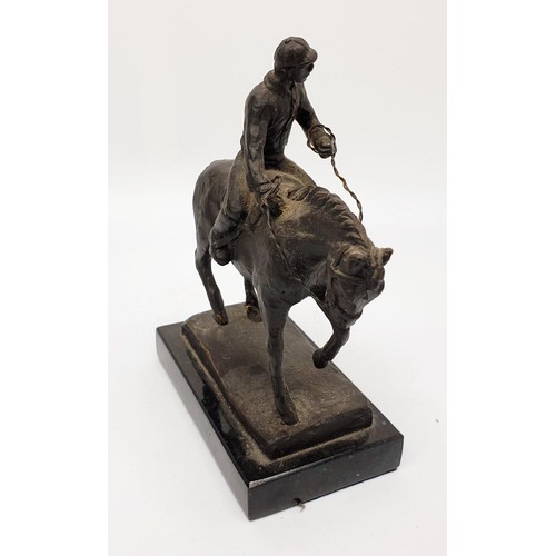 246 - A cast metal sculpture of a horse and jockey on a marble plinth, height 16cm. UK shipping £14.