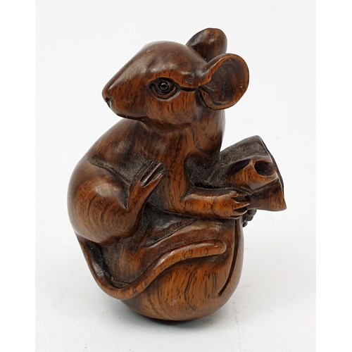A carved wooden netsuke in the form of a mouse on a sack, height 4.5cm ...