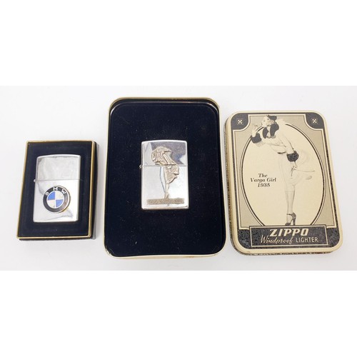 53 - A BMW Zippo lighter, a Varga Girl Zippo lighter, a Zippo 1 cent coin, Zippo ephemera and two other l... 