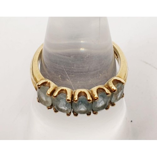 10 - A hallmarked 9ct gold ring set with five pale blue stones, gross weight 3.15g, size O. No internatio... 